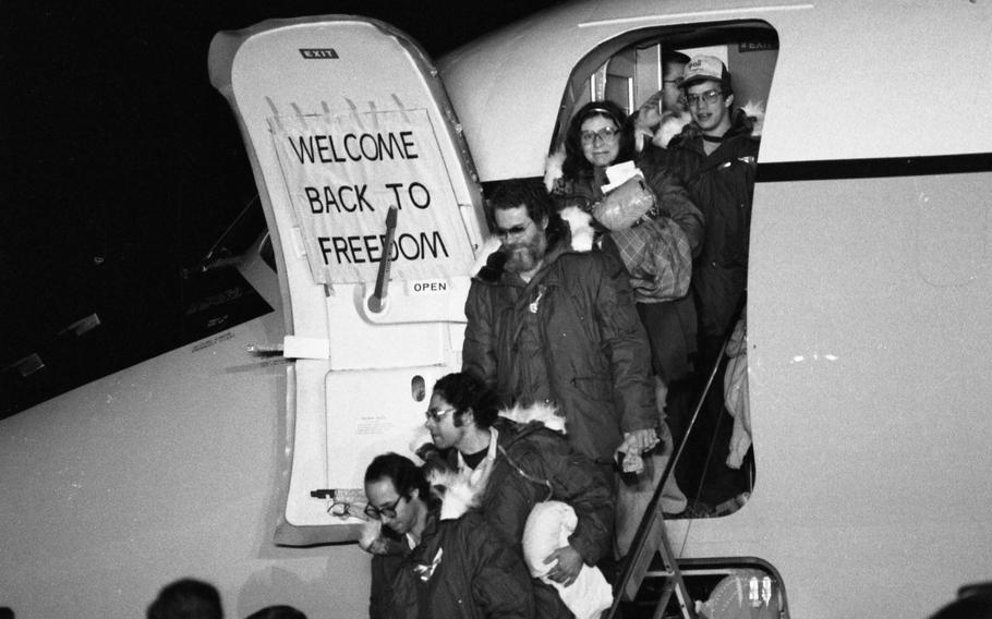 Hostages emerge to cheers as they step out of one of the two C-9 planes that ferried them from Tehran, Iran, to Rhein-Main Air Base in Germany. 
