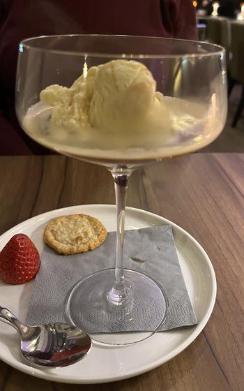 A scoop of vanilla ice cream with a shot of espresso is served in a champagne coupe at Mathilda in Wiesbaden, Germany. The espresso was poured over the ice cream by the server at the table.