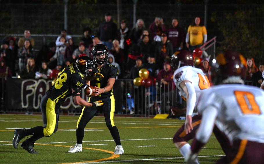 Panthers senior QB Ty Jones hands the ball off to Senior RB Jack Gruver during their opening drive of the Division I championship game against the Vilseck Falcons on Oct. 28, 2023, at Stuttgart High School.