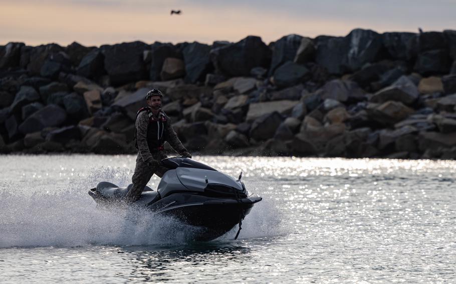 A U.S. Marine with Bravo Company, 1st Reconnaissance Battalion, 1st Marine Division, rides on a personal watercraft as a safety observer during training in Del Mar Boat Basin as part of Steel Knight 23 on Marine Corps Base Camp Pendleton, Calif., Dec. 2, 2022. 