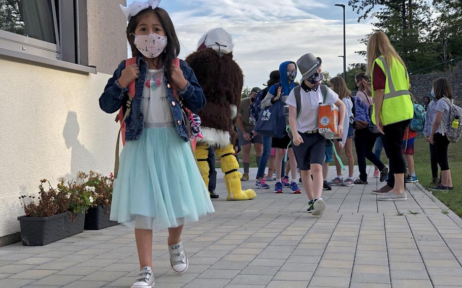 Student walks to class on the first day of school in August 2020 at Vogelweh Elementary School, Germany. Face masks will be required indoors for students and teachers at Defense Department schools when the new school year starts, including for those who are already vaccinated against the coronavirus, school and military officials said.