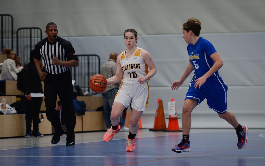 Stuttgart's Isabella Henderson, left, runs past Wiesbaden's McKinley Viers at the DODEA European Division I girls basketball championships Feb. 16, 2023, at Ramstein Air Base, Germany. Wiesbaden beat Stuttgart 50-15.