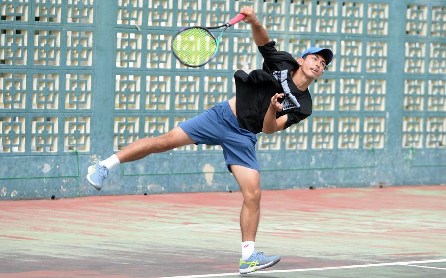 Yokota's Ryunosuke Roesch follows through on serve en route to a 6-0, 6-3 Far East tournament boys singles final win over Humphreys' Elliot Lee.