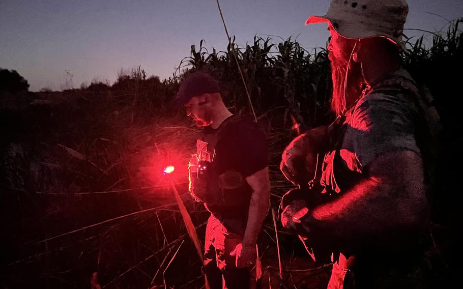 Samuel Hall, left, and Shawn Tredway patrol the Rio Grande near Border Patrol agents and National Guard troops in Eagle Pass, Texas. 