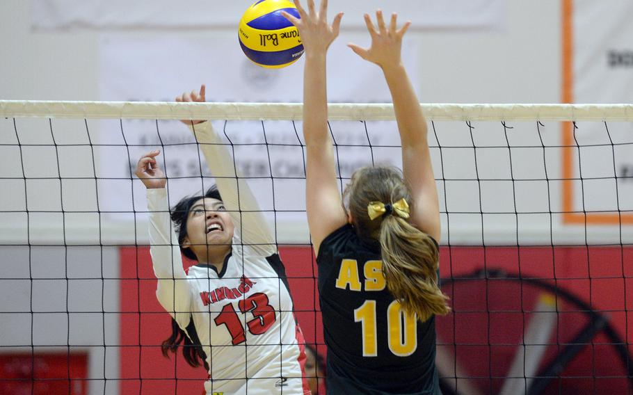 Nile C. Kinnick's Cierra San Nicolas spikes against American School In Japan's Lily Stone-Bourgeois during Tuesday's Kanto Plain volleyball match. The Red Devils won in five sets.