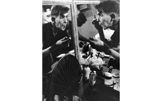 Seoul, South Korea, September 1956:  Pvt. Ed Campbell applies stage makeup to transform himself into "Mercedes Montecarlo," for his role in the 7th Infantry Division Special Services show "Uncle Tom-a-san's Hoochie." The show, using songs from top Broadway musicals, was written by Pvt. 1st Class Tom Wright of 7th Inf. Div. Special Services, and  directed by Jack Badcock, Special Service director. 

The so-called "soldier shows" - shows created by and for soldiers - had one main objective: keeping morale high through entertainment. With virtually all production jobs - acting, directing, writing, costume and stage design, etc. - done by servicemembers, the shows created camaraderie and boosted morale of both the participants and the servicemembers that came to see them. Often borrowing heavily from European cabaret, and vaudeville, the shows were a mix of comedy/skits, and song and dance routines, parts often performed by soldiers dressed and made up as women. Drag show elements have been an integral part of soldier shows throughout the decades in not just the U.S. military, but militaries around the world, as well as many fraternities and all-male clubs and organizations.

Read the 1956 article accompanying the above photograph and see additional images here. 

Want to learn more about the history of drag performances in the U.S. military? Check out The National WWII Museum’s article on the subject here. [https://www.nationalww2museum.org/war/articles/drag-entertainment-world-war-ii]

In May this year the Department of Defense chose to enforce an existing policy on standards of conduct and ethics, banning the use of DOD funds, equipment and facilities for drag performances on military bases.
