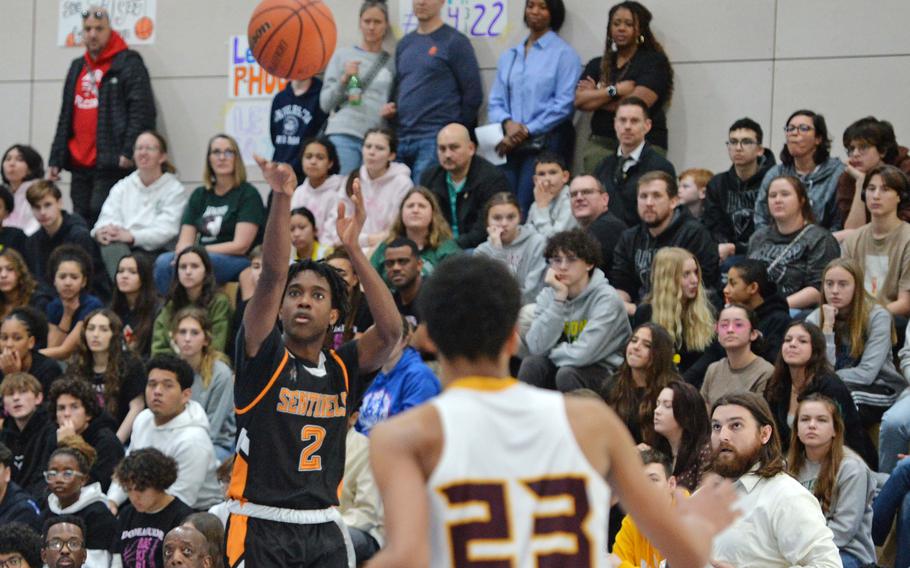 Spangdalems Makario Drummond shoots a three-pointer in the Division III championship game at the DODEA-Europe basketball finals in Ramstein, Germany, Feb. 18, 2023. Baumholder won 40-27 to take the title.