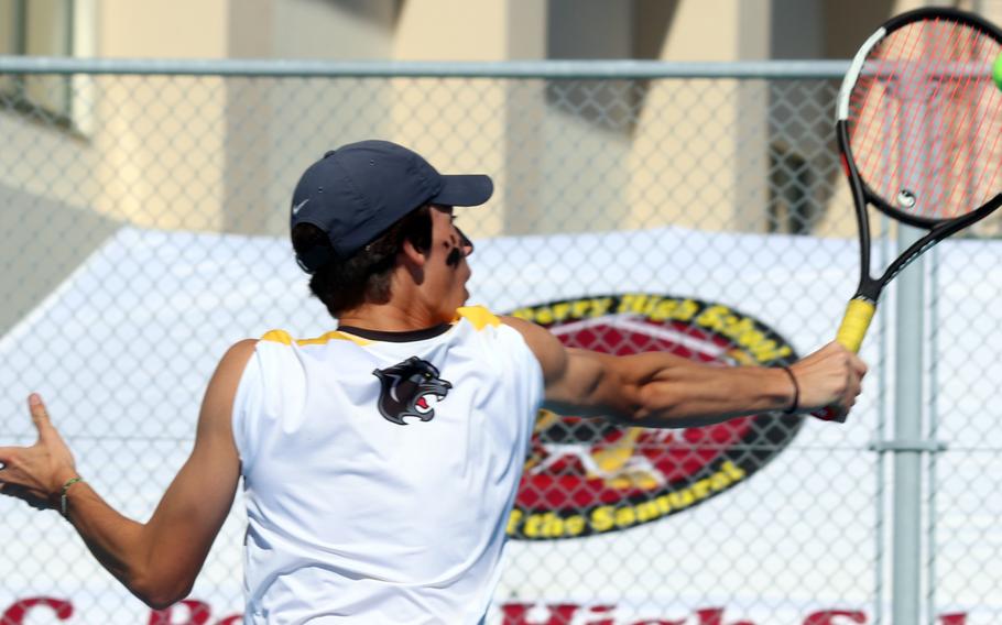 Kadena's Evan Davis smacks a backhand return against Kubasaki's Owen Ruksc in the boys singles final.