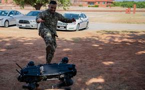 Master Sgt. Jaime Gutierrez, plans and programs superintendent for the 7th Security Forces Squadron, performs a durability and strength test on a robot dog at Dyess Air Force Base, Texas, Aug. 5, 2022.