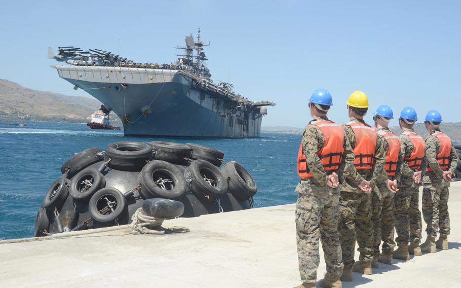 Marines watch the arrival of the amphibious assault ship USS Iwo Jima in Souda Bay, Greece, on May 27, 2021. A new defense pact between the U.S. and Greece could give U.S. forces access to an additional base at Souda Bay on the island of Crete.