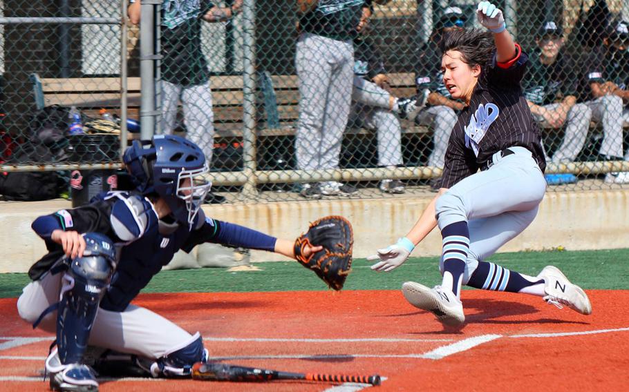 Osan's Adam Rutland slides home ahead of the throw to Daegu's Chris Garcia during Saturday's DODEA-Korea baseball game. The Cougars won 7-4.