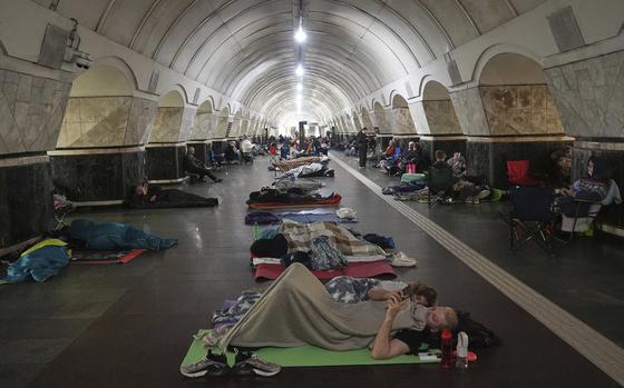 People lying on the floor of a metro station.