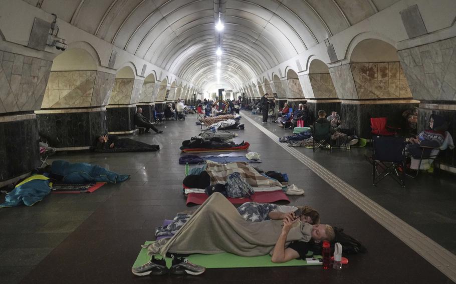 People lying on the floor of a metro station.