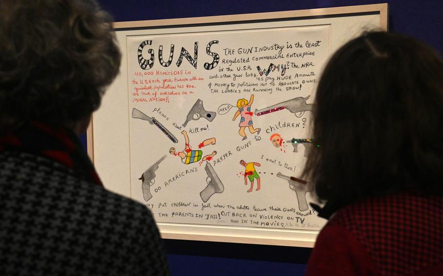 Visitors to the Niki de Saint Phalle exhibit at the Schirn in Frankfurt, Germany, study her work “Guns,” from 2001.
