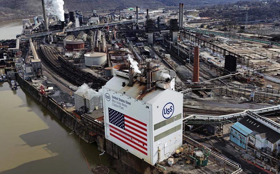 An aerial view of a U.S. Steel plant by a river.