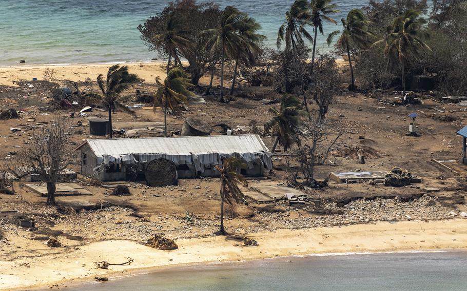 In this photo provided by the Australian Defense Force, debris from damaged building and trees are strewn around on Atata Island in Tonga on Jan. 28, 2022, following the eruption of an underwater volcano and subsequent tsunami. Coronavirus cases continue to rise rapidly in Tonga, and tests have confirmed that the particularly contagious omicron variant is behind the isolated Pacific island nation's first community outbreak since the start of the pandemic, officials said Thursday, Feb. 10, 2022. 