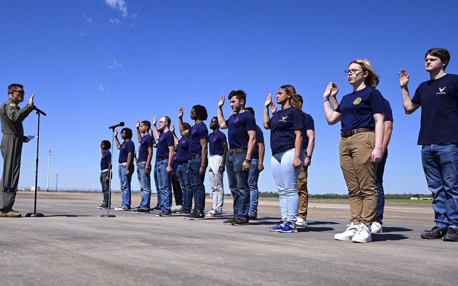 Air Force Col. Scott Weyermuller swears in new recruits at the Defenders of Liberty Air Show at Barksdale Air Force Base, La., on March 25, 2023. New Senate legislation seeks to address shortfalls in military recruitment.