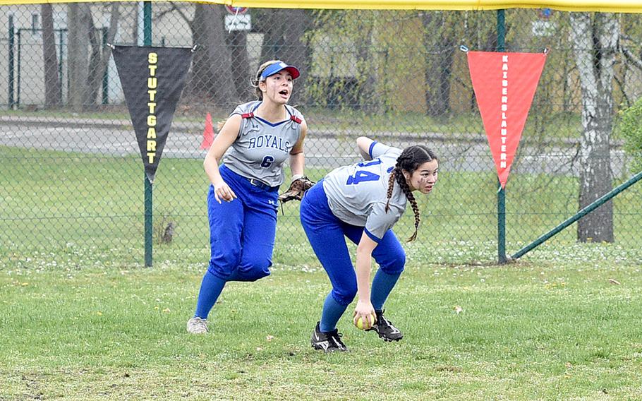 Ramstein outfielder Emma Inthavixay picks up the ball during the second game of the Royals' doubleheader Saturday against Kaiserslautern on Ramstein Air Base, Germany. Backing her up is fellow outfielder Natalie Briceland.