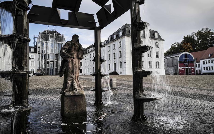 The grand entrance to the Saarbruecken Palace and pavestones marking the Invisible Memorial, in Saarbruecken, Germany, on Oct. 19, 2023. In the 1990s, college students removed pavestones and engraved them with the locations of Jewish cemeteries in Germany before placing them back, face-down, in front of the palace as a silent remembrance of the victims of the Nazi regime. 