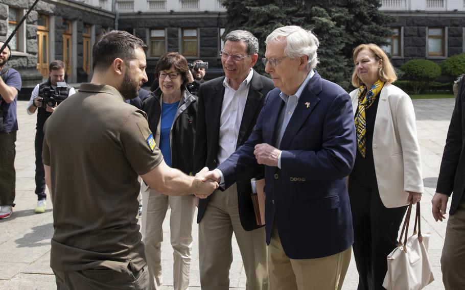 Ukrainian President Volodymyr Zelenskyy, left, shakes hands with Senate Minority Leader Mitch McConnell, R-Ky., in Kyiv, Ukraine, Saturday, May 14, 2022. 