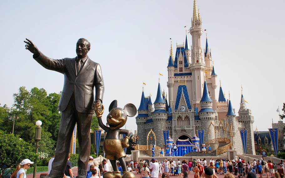 A statue of Walt Disney with Mickey Mouse outside the entrance to Cinderella’s Castle at Disney World in Orlando, Florida. Disney has paused its vaccine mandate for Florida employees in response to restrictions passed by the Legislature earlier this week. 