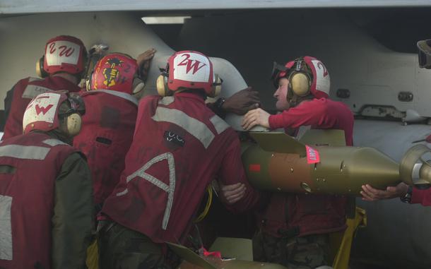 Hed: Ordnance, 2003

Aboard USS Kitty Hawk, Mar. 20, 2003: Aviation ordnancemen load a precision-guided bomb on an F/A-18 Hornet on the USS Kitty Hawk. Carrier Air Wing 5 flew 35 daytime sorties and 56 nighttime sorties, 42 of which were strike sorties on Iraq.

META TAGS: Operation Iraqi Freedom; Wars on Terror; U.S. Navy; 