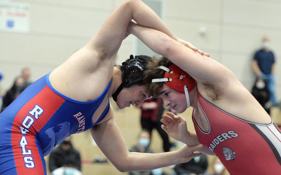 Ramstein’s Colten Lee Ploetz and Kaiserslautern’s Caden Bellmore try to get the advantage over each other in the 215-pound final at the high school 2022 Wrestling Tournament in Ramstein, Germany, Feb. 12, 2022. Bellmore went on the capture the title.