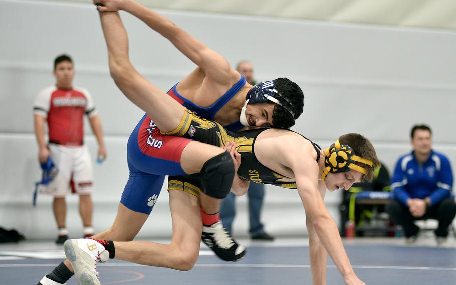 Ramstein's Jesus Olivares picks up Stuttgart's Brayden Aperauch's leg during the 113-pound championship match at the DODEA Central Europe wrestling sectional on Saturday at Ramstein High School on Ramstein Air Base, Germany. Olivares won the match, 14-10.