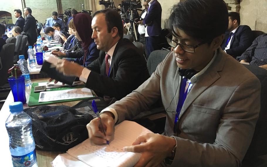 Stars and Stripes reporter J.P. Lawrence, right, reports from a national security conference in Herat, Afghanistan, on Oct. 26, 2018.