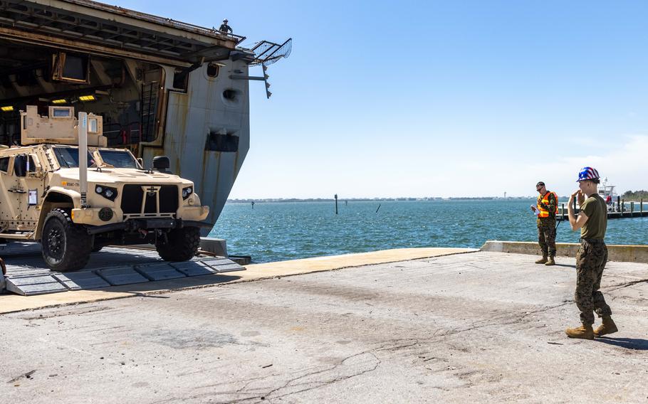 U.S. Marine Corps Cpl. Taylor Keaton, an MV-22B Osprey tiltrotor mechanic assigned to Marine Medium Tiltrotor Squadron 162 (Reinforced), guides a Joint Light Tactical Vehicle while offloading from San Antonio-class amphibious transport dock ship USS Mesa Verde (LPD 19) after returning from deployment with the 26th Marine Expeditionary Unit, Morehead City, N.C., Sunday, March 17, 2024.