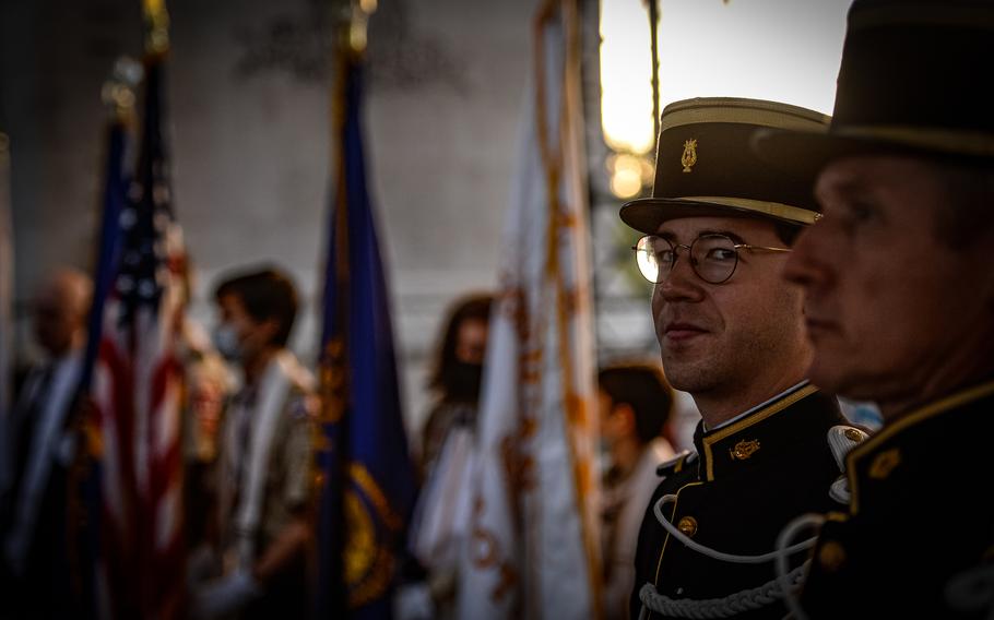 A ceremonial bugle player awaits the beginning of ceremonies at the Arc de Triomphe, in Paris, Oct. 26, 2021. 