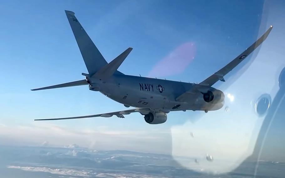 In this screenshot from a Russian Defense Ministry Facebook post, a Russian Su-30SM fighter pilot's helmet is reflected in the plane's cockpit as it follows a U.S. Navy P-8 Poseidon over the Black Sea, July 6, 2021. Russian military actions in response to NATO's annual Sea Breeze exercise were more frequent, hostile and aggressive than in years past, some analysts said.