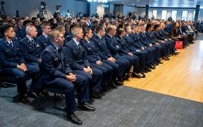 Rows of people seated in Space Force uniforms in an auditorium.