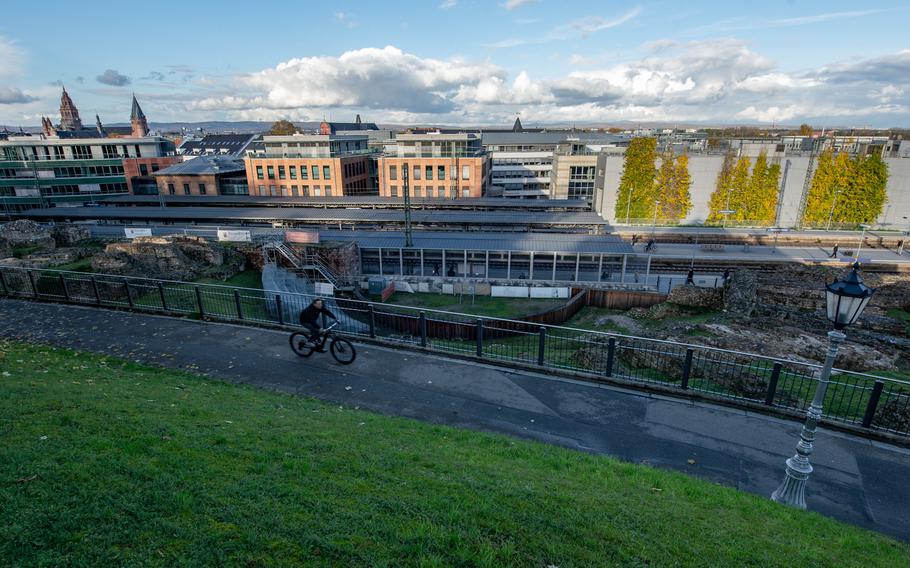 A bicyclist rides past the Roman theater in Mainz, Germany, on Nov. 18, 2022. The theater was rediscovered during construction of the rail line that now runs over the former theater grounds.