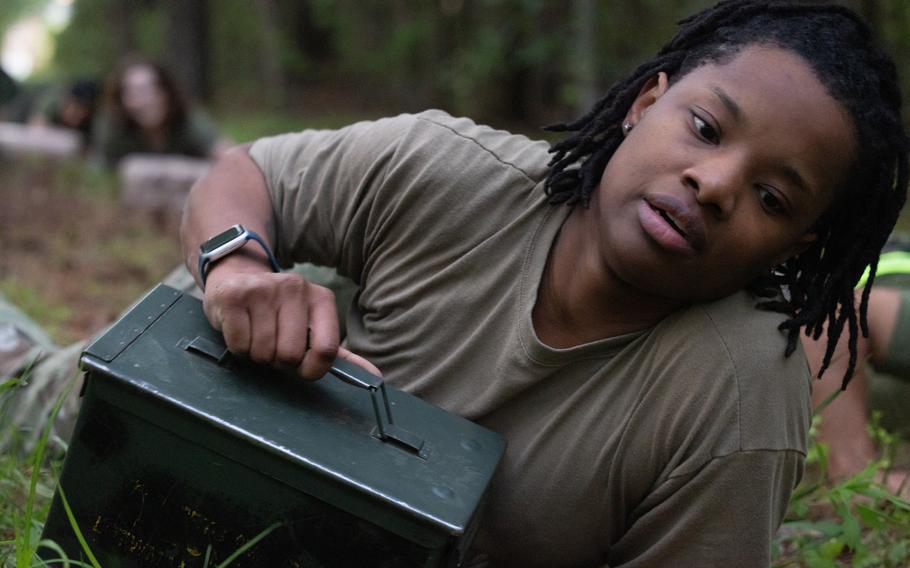 An airman crawls with an ammo can