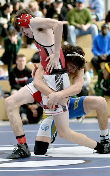 Kaiserslautern's Braxden Gransbery tries to get out of the grasp of Wiesbaden's Landon Escobar during a 126-pound match at Ramstein High School on Saturday at Ramstein Air Base, Germany.