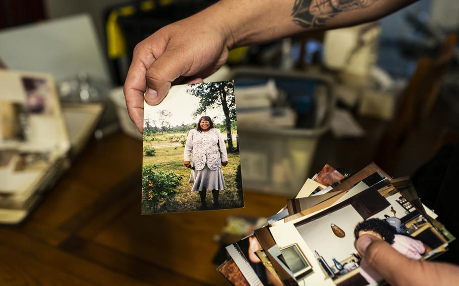 Shane Steindorf holds a photograph of his mother who died from covid-19 on May 5. 