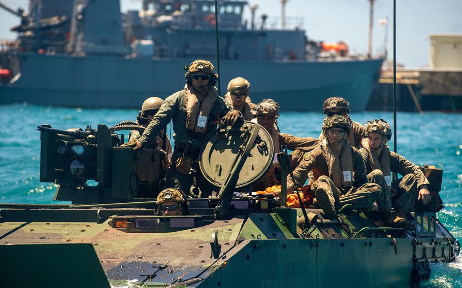Marines of the 15th Marine Expeditionary Unit prepare for a troop transfer during an Amphibious Combat Vehicle egress drill at White Beach Naval Facility, Okinawa, Japan, June 24, 2024.