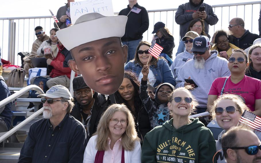 Families await the  USS George H.W. Bush before its return to Naval Station Norfolk following an eight-month deployment, Sunday, April 23, 2023.