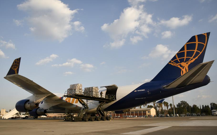 Airmen unload pallets of humanitarian aid, including medical beds, from a cargo plane at Incirlik Air Base, Turkey, Feb. 22, 2023. The aid is part of relief in the aftermath of the Feb. 6 earthquakes that have since left at least 46,000 dead in Turkey and Syria.