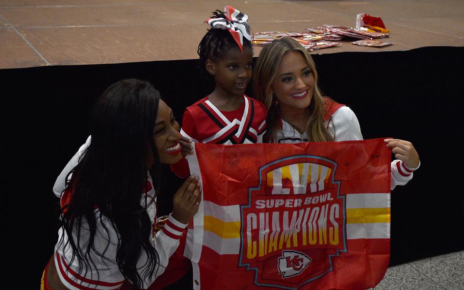 Taleah Lane, center, poses with Kansas City cheerleaders Taylor, left, and Regan, right, during an autograph signing Nov. 2, 2023, at Ramstein Air Base, Germany.