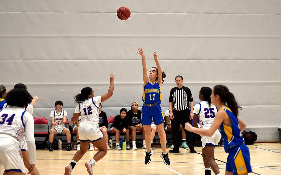 Wiesbaden guard Angelica Shea shoots over Ramstein guard Parker Ingram during pool-play action of the DODEA European basketball championships on Feb.14, 2024, at the Wiesbaden Sports and Fitness Center on Clay Kaserne in Wiesbaden, Germany.