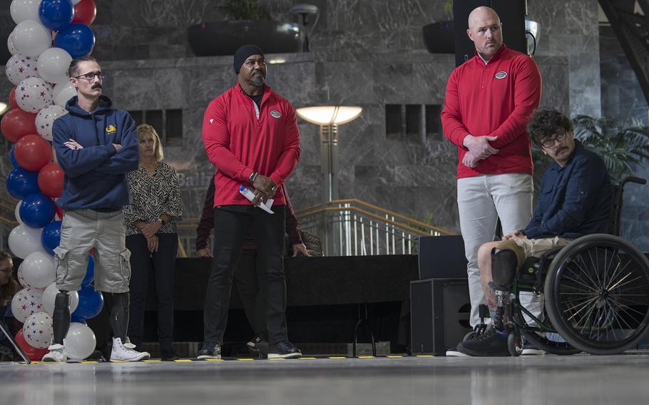 From left, wounded Navy veteran Chris Andrieu, retired Eagles safety Brian Dawkins, retired Cowboys tight-end Jason Witten and wounded Army veteran Thomas Brooks gather inside the Philadelphia Convention Center on Friday, Dec. 9, 2022, just prior to a charity event in which the two wounded veterans received free vehicles.