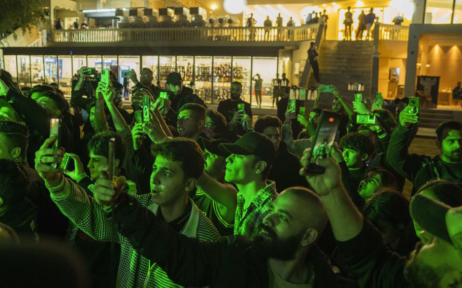 Youths gather along the Tigris River for a concert by rap artist OG Khalifa in Baghdad, Iraq, Saturday Feb. 25, 2023. One of the songs he performed mocks “sheikhs,” those who wield power in the new Iraq through wealth or political connections.