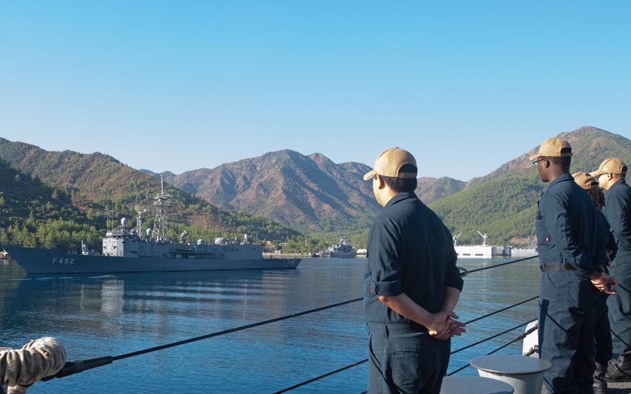 U.S. Navy sailors aboard the destroyer USS Forrest Sherman man the rails while passing the Turkish navy frigate TCG Gemlik during a sea and anchor transit into Aksaz, Turkey, Sept. 9, 2022, ahead of NATO Exercise Dynamic Mariner/Mavi Balina 22.