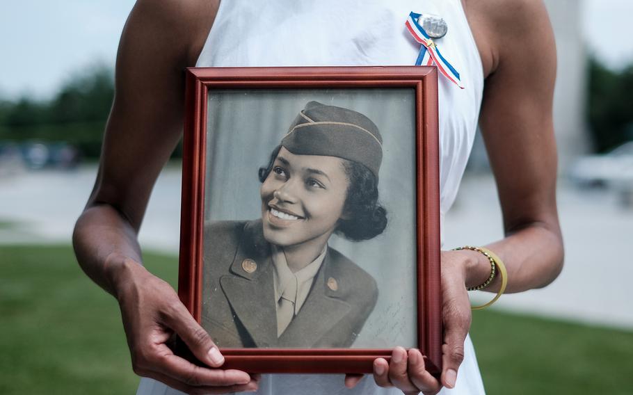 Maia Semmes holds a photograph of her aunt Pvt. Margaret Sales, a member of the 6888th Central Postal Directory Battalion, an all-Black, all-female World War II unit honored Wednesday at the Military Women’s Memorial in Arlington National Cemetery. 