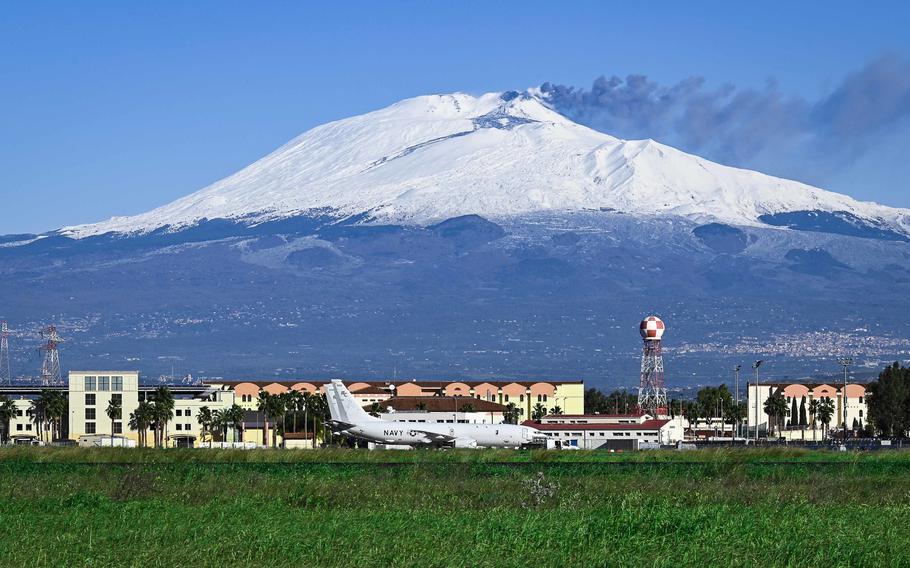 Mount Etna, an active volcano on the island of Sicily, rises behind Naval Air Station Sigonella on Jan. 4, 2021. The volcano erupted over the weekend, spewing ash and rocks over parts of eastern Sicily, including NAS Sigonella.