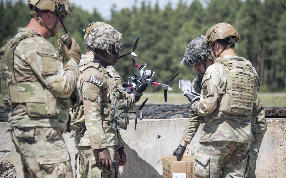 U.S. soldiers prepare to launch a Skydio X10D drone fixed with a dummy M67 grenade.