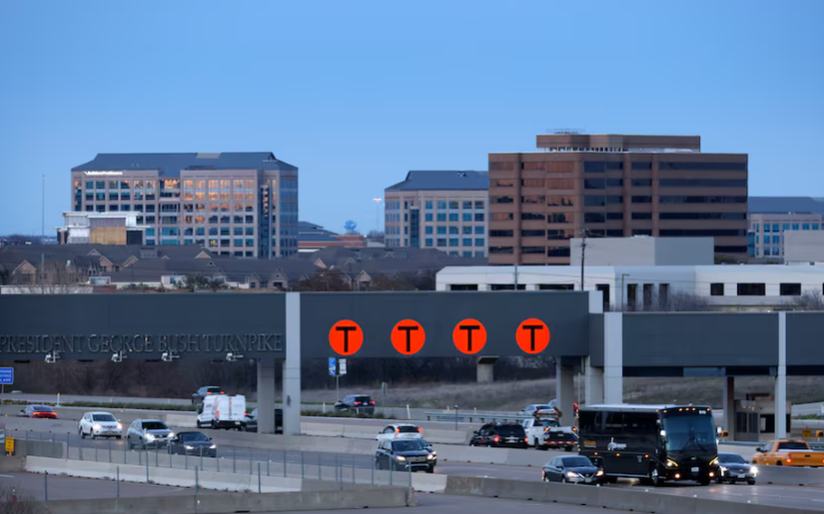 Evening traffic crosses under the President George Bush Turnpike station