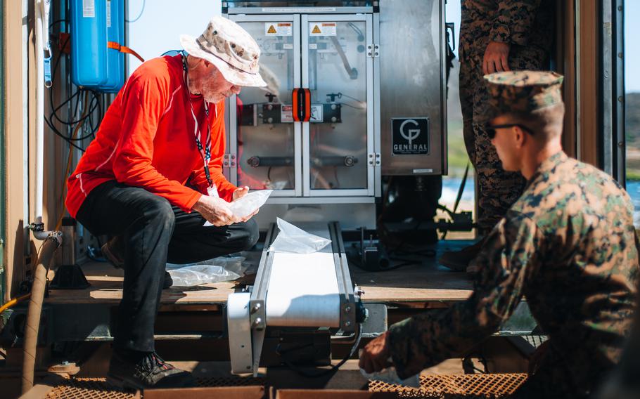 U.S. Marines with 3rd Littoral Logistics Battalion, 3rd Marine Littoral Regiment, 3rd Marine Division, work alongside representatives of U.S. Indo-Pacific Command Logistics Science and Technology to operate the Atmospheric Portable-water Sustainment Unit at Marine Corps Base Hawaii, Sept. 30, 2022.